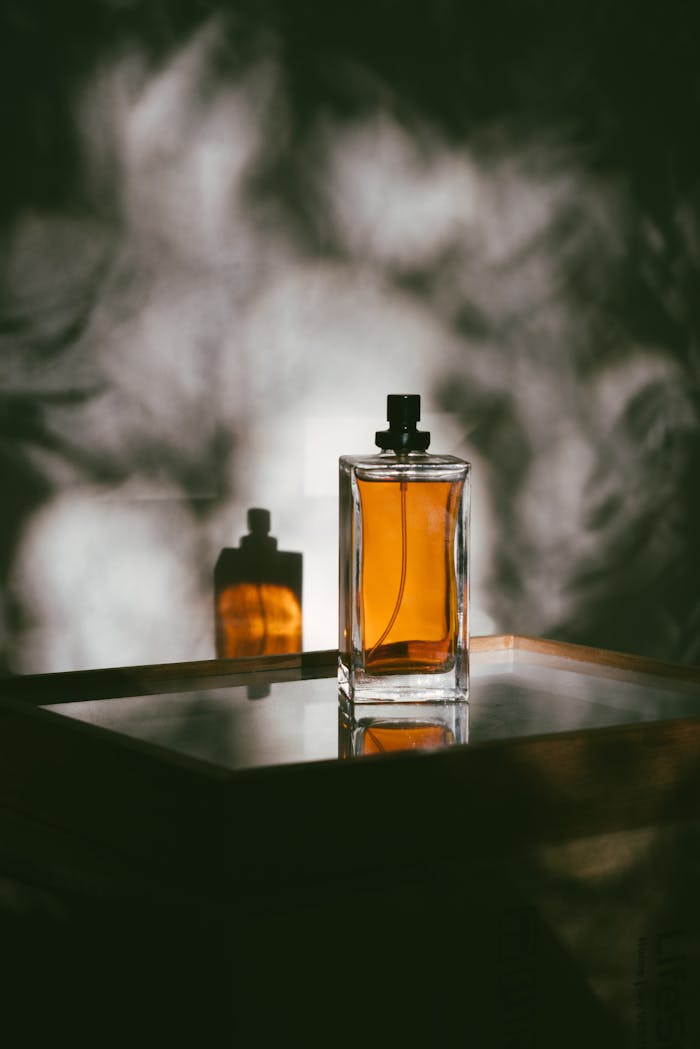 Crafting Captivating Headlines: Your awesome post title goes here A stylish perfume bottle casting shadows on a reflective surface, creating a moody ambiance.